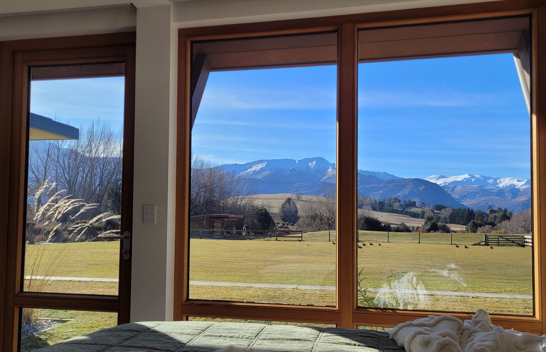 View from a bedroom across the paddock to the mountains