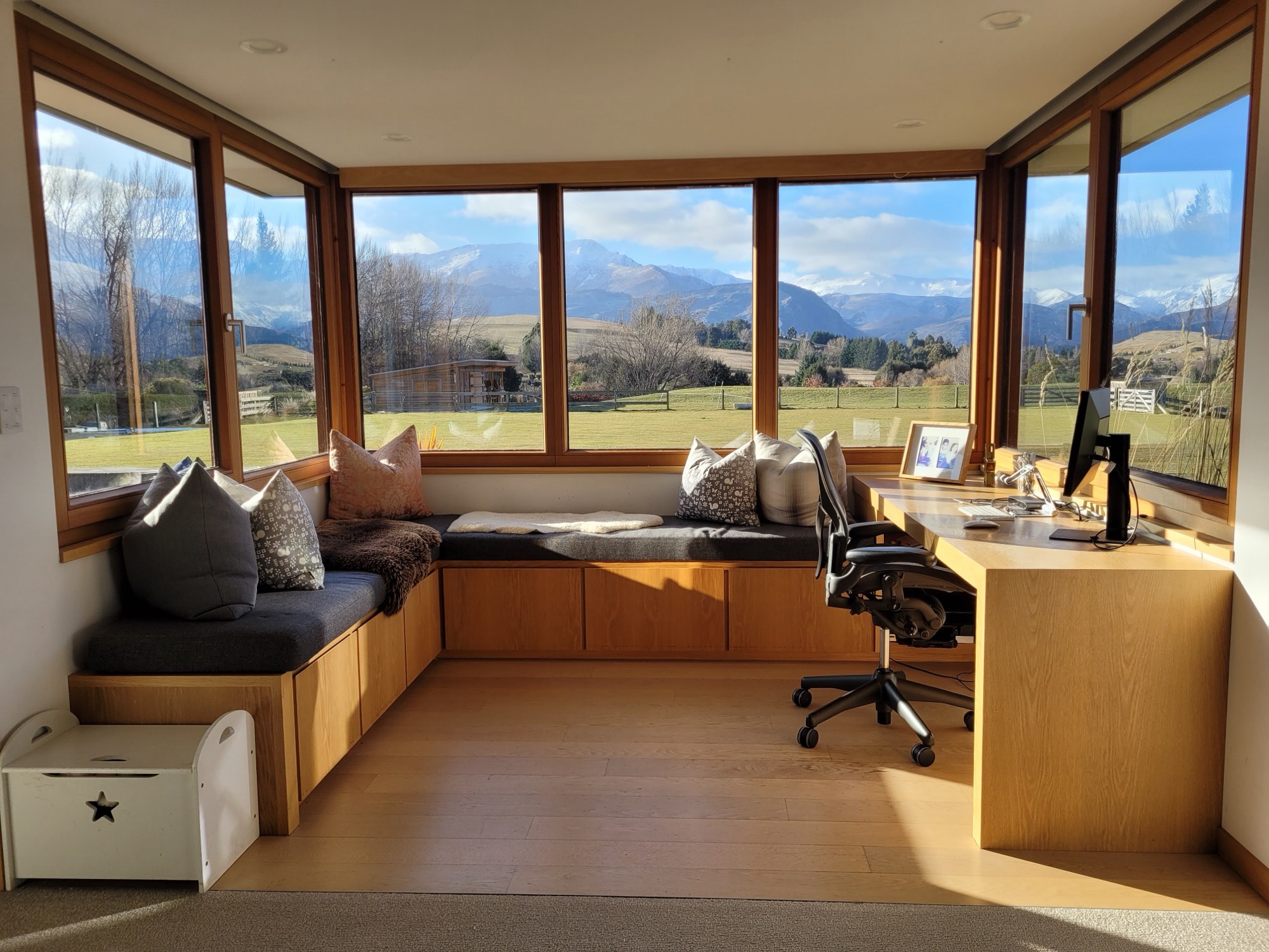 A window seat and desk wrapped in glazing