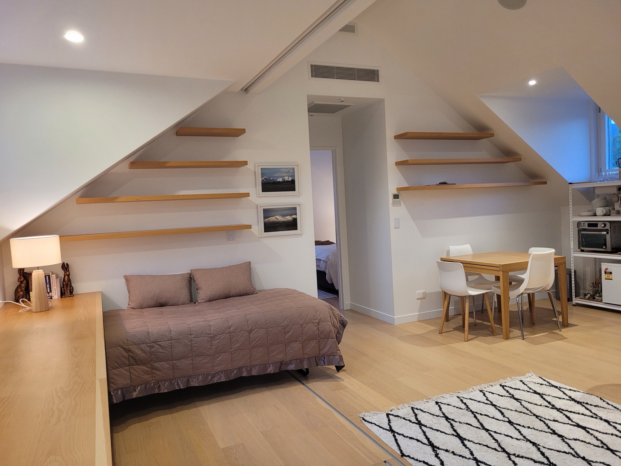 The second single bed, with the dining end beyond
