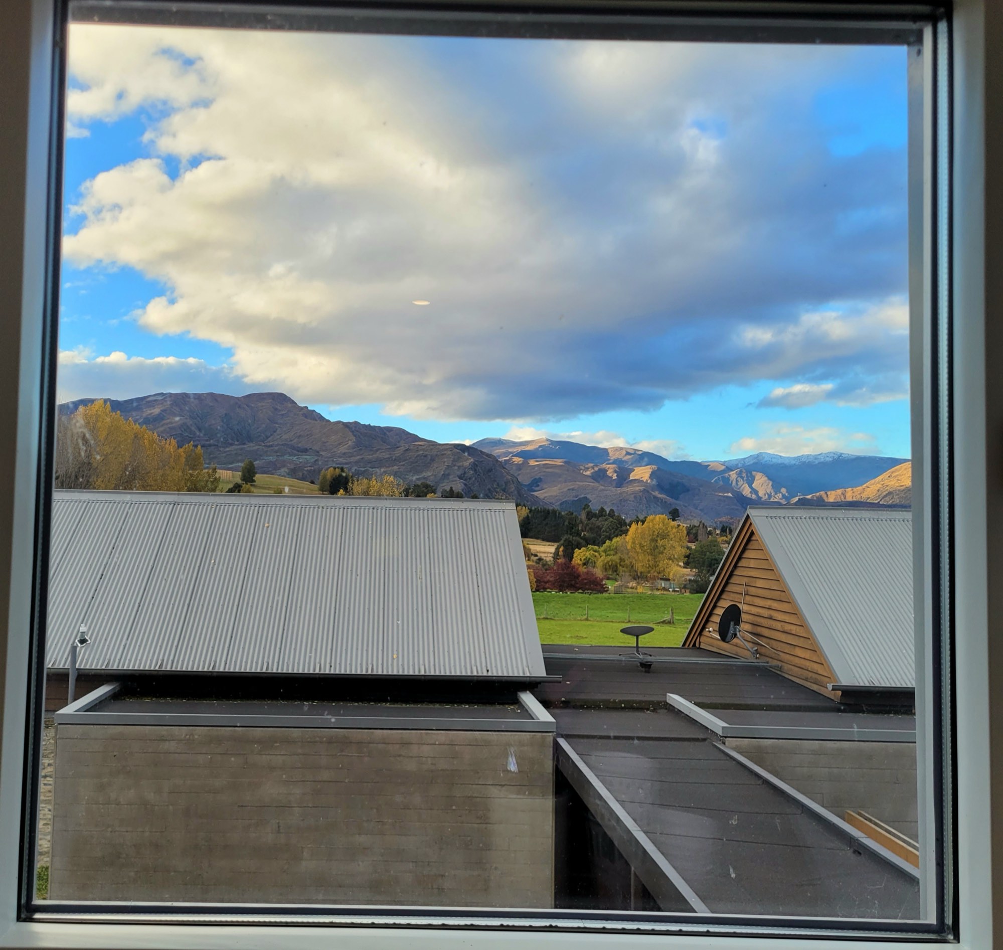 The view from the loft dormer, over the homestead roof to the mountains