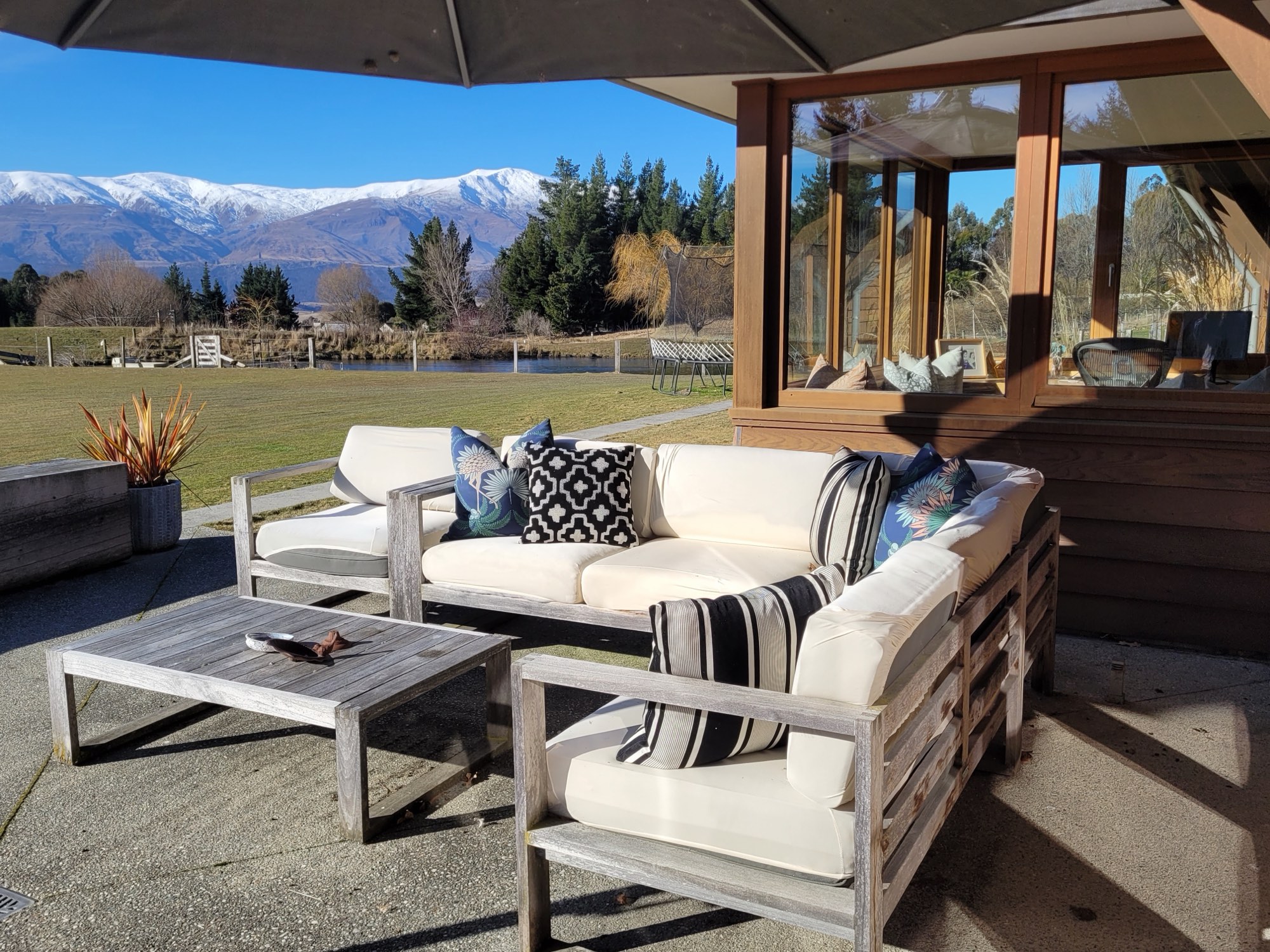 The outdoor lounge under the umbrella, snow on the tops