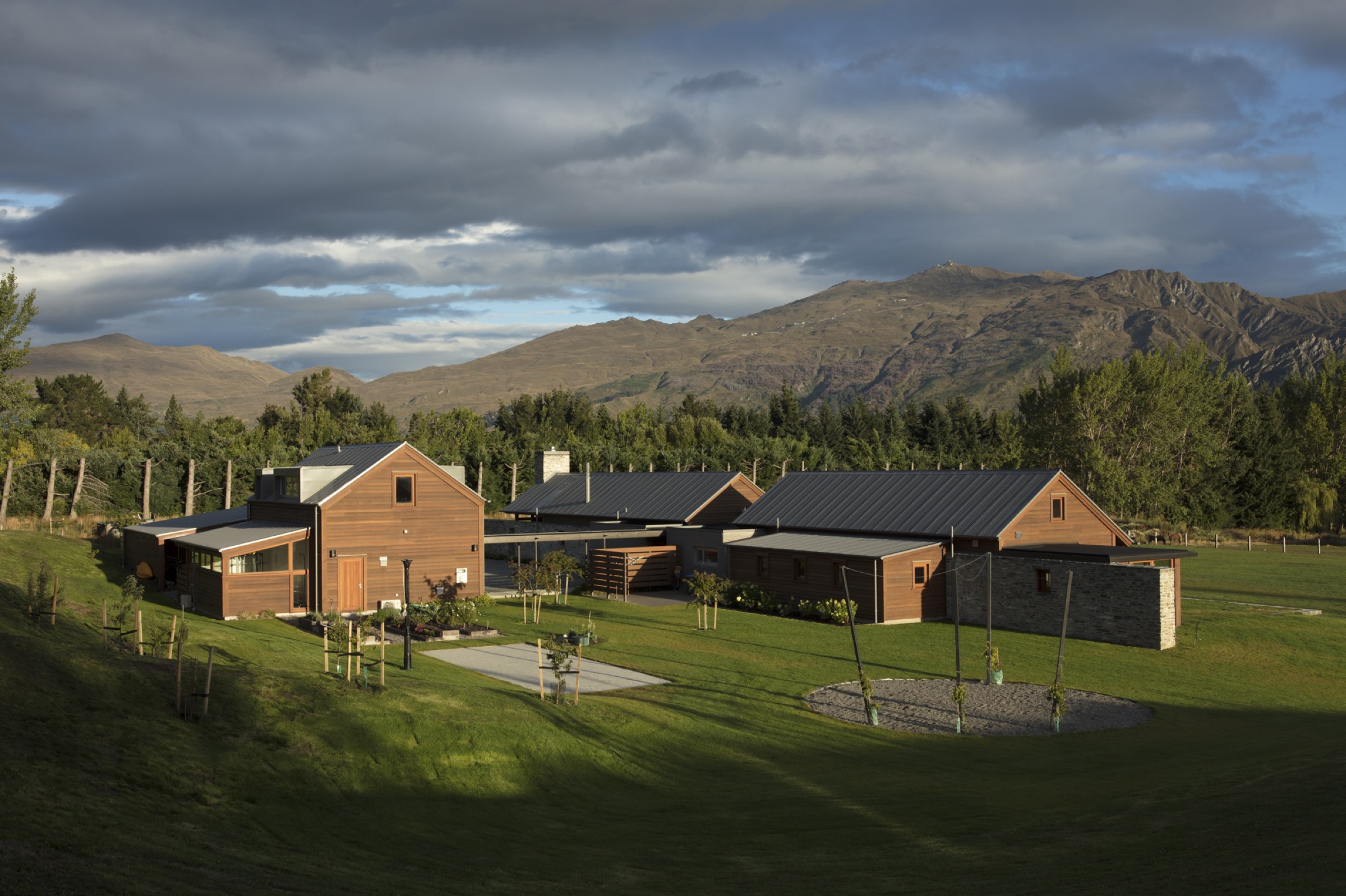 Both buildings at dusk, seen across the lawn