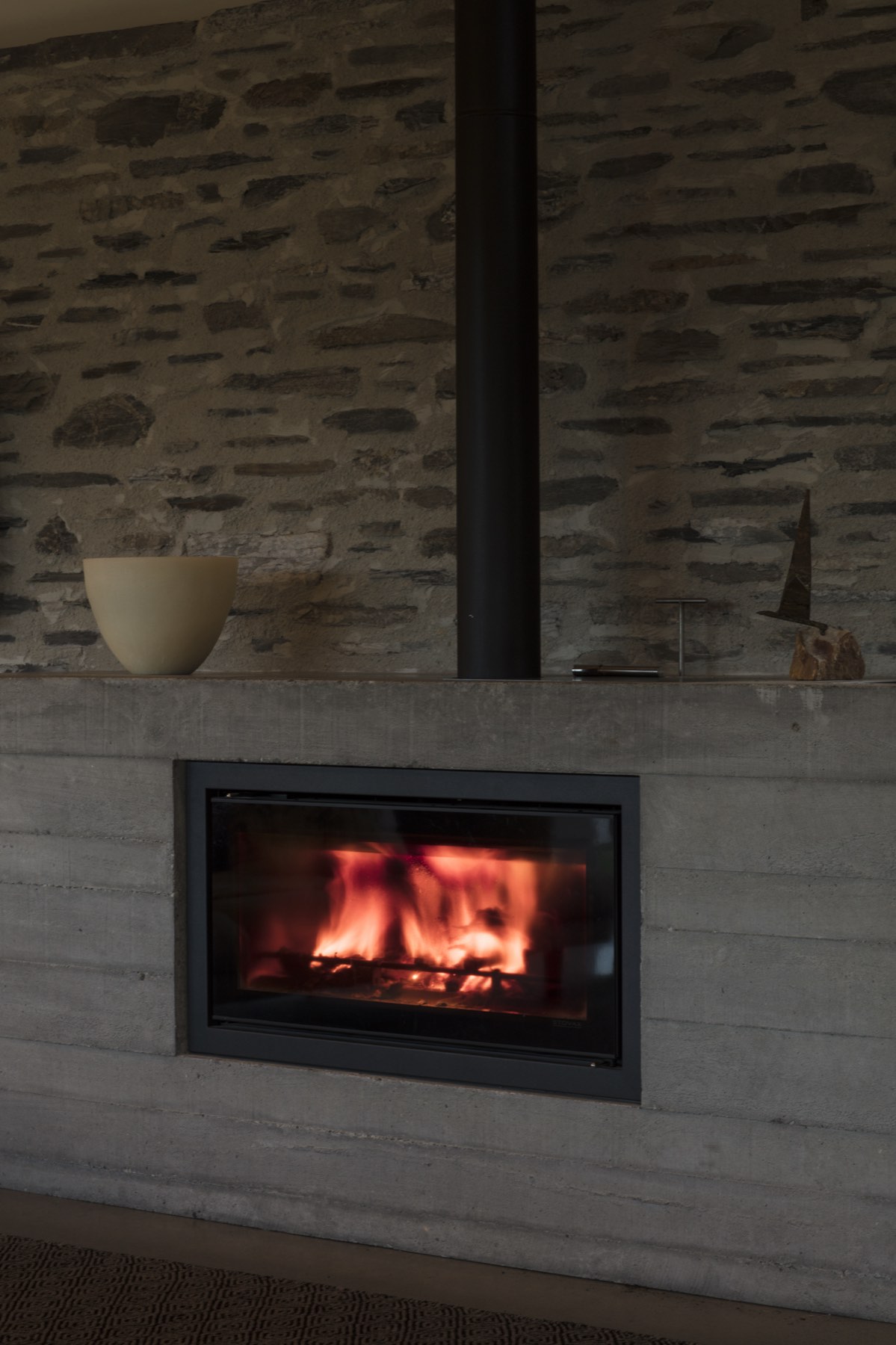The log burner set into its concrete hearth