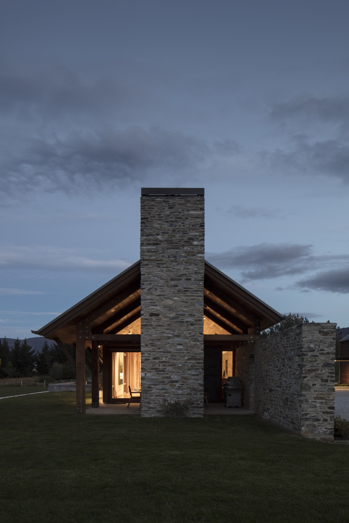 The gable end at dusk, windows lit