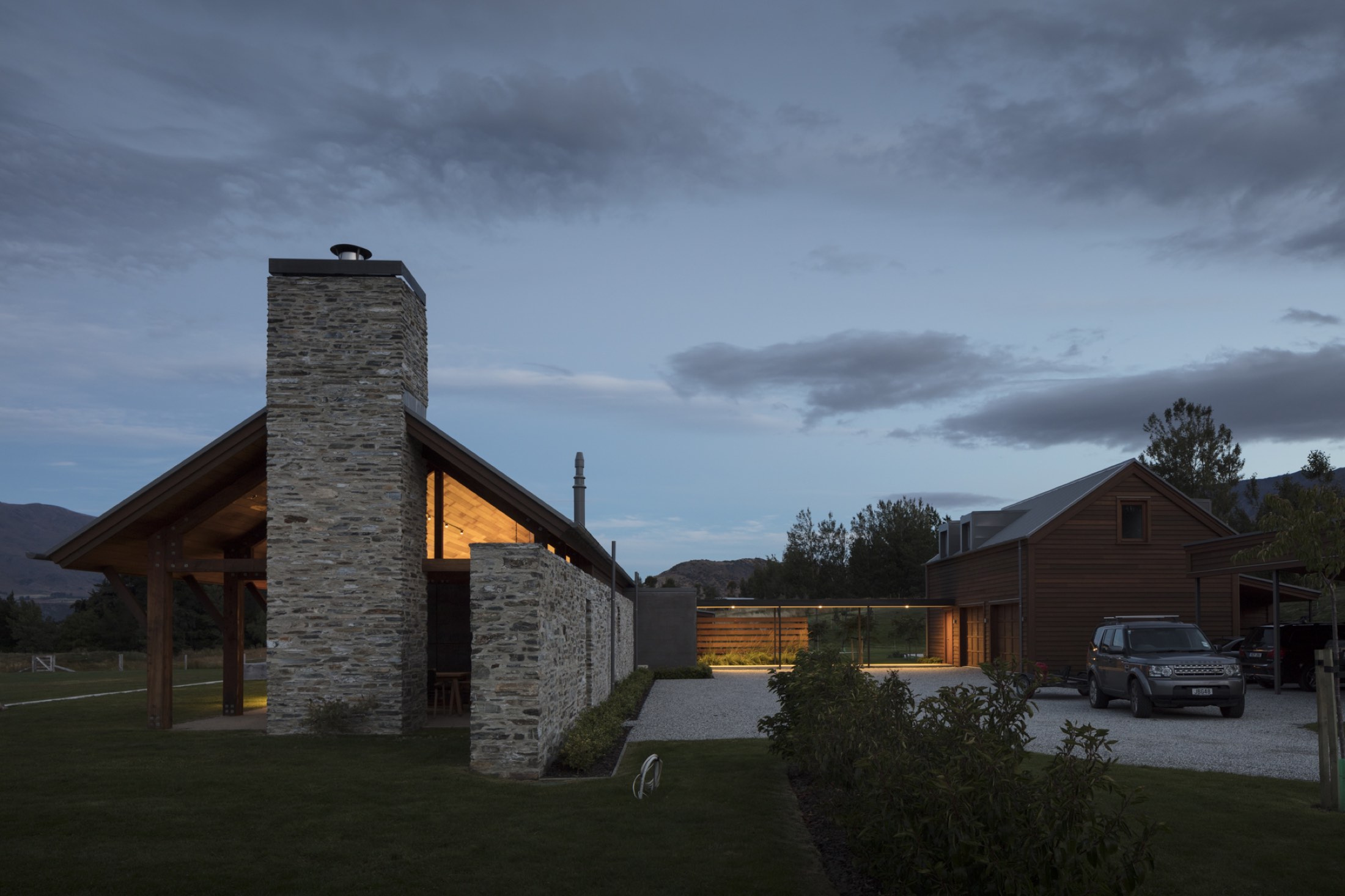 The gable end at dusk, windows lit