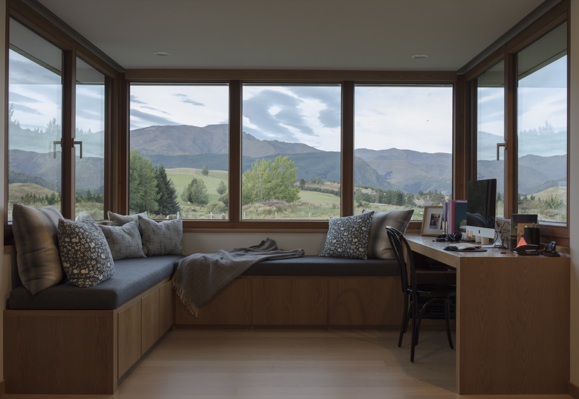 The window seat and the desk, wrapped in glazing on three sides