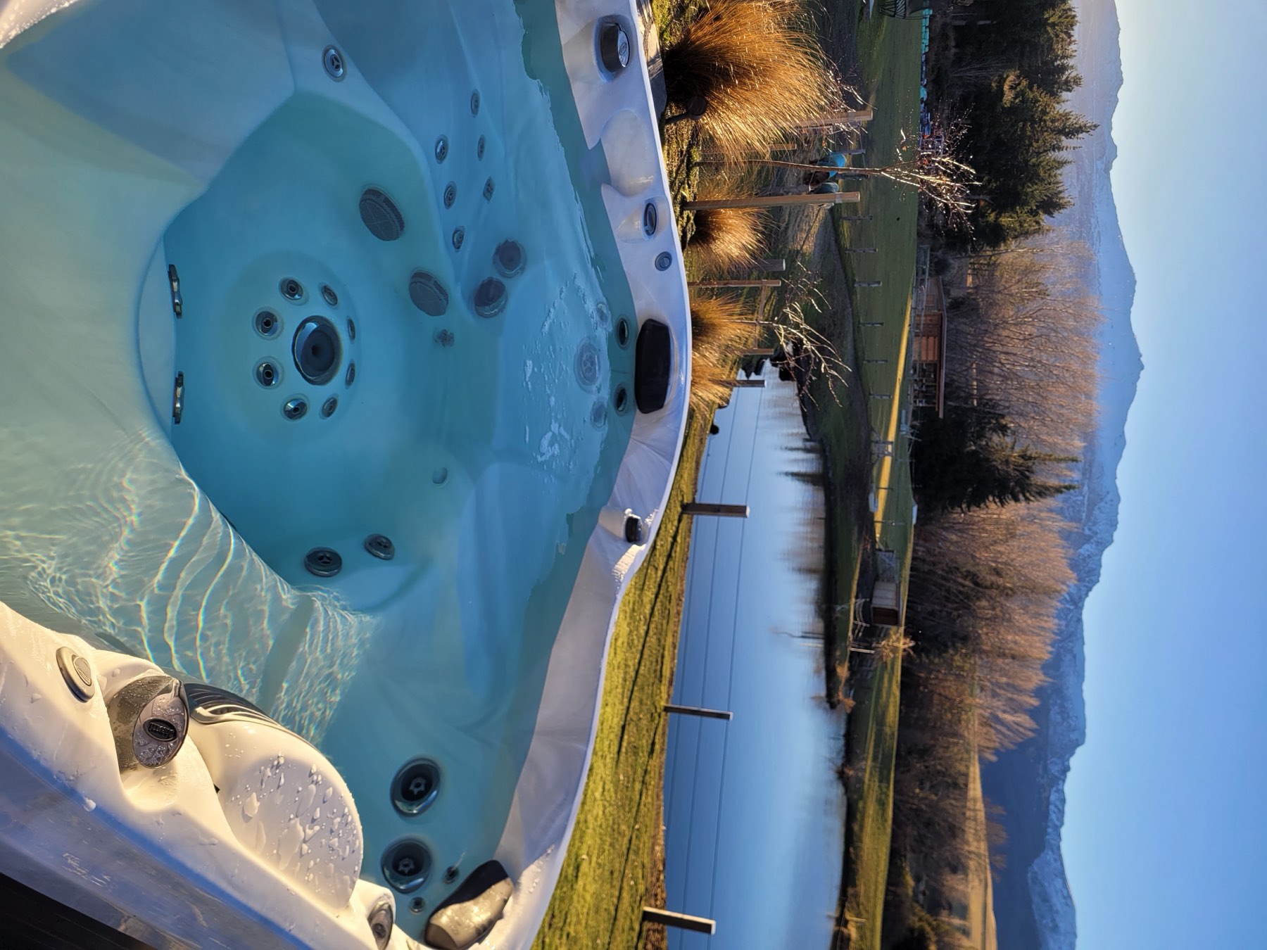 Outdoor spa looking across the pond to the mountains
